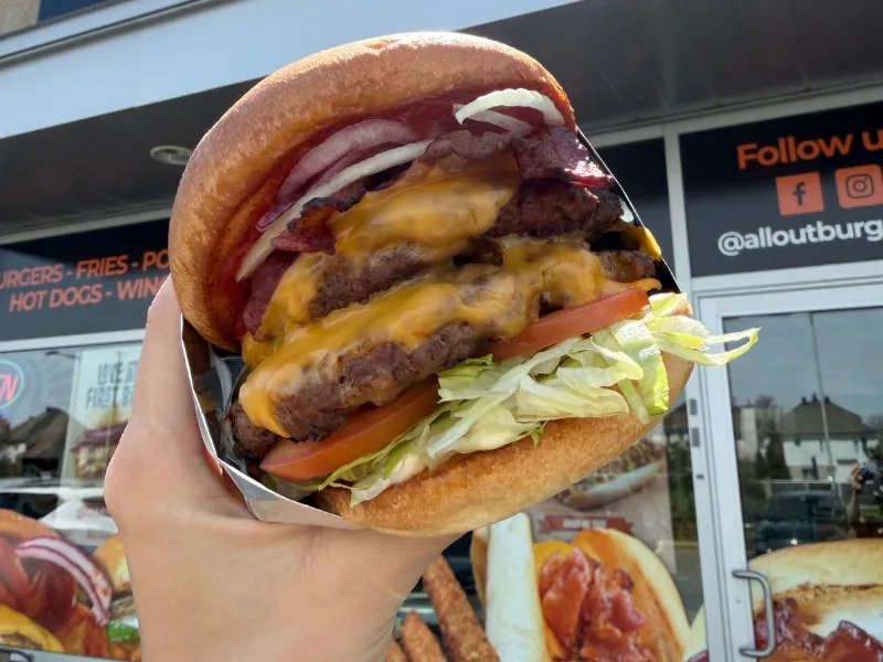 An All-Out Burger served in its branded wrapper